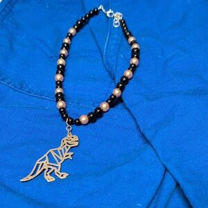 Elegant Dinosaur Pendant Necklace - Black and Gold